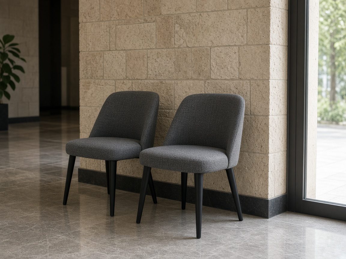 Two empty visitor chairs just inside a lobby.