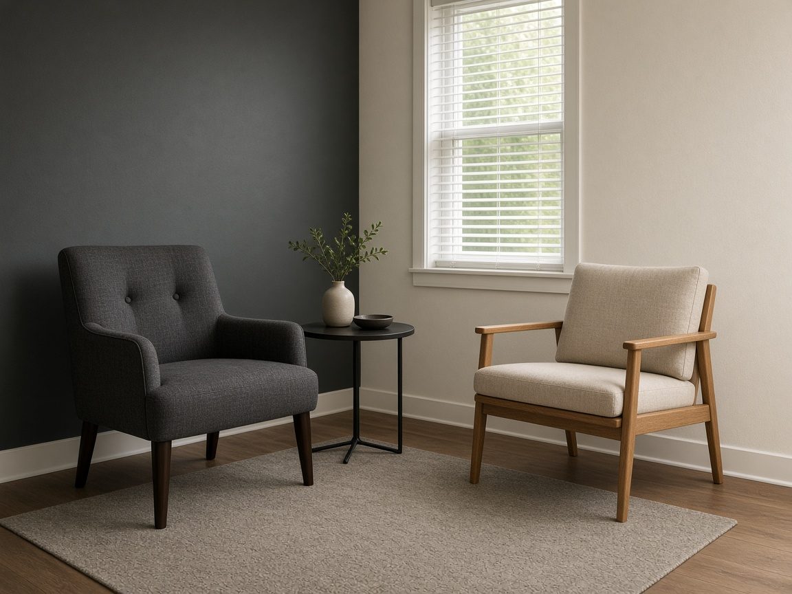 A formal chair and a simpler chair in a quiet office corner.