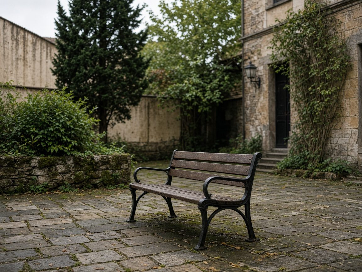 An empty bench in a planted courtyard.
