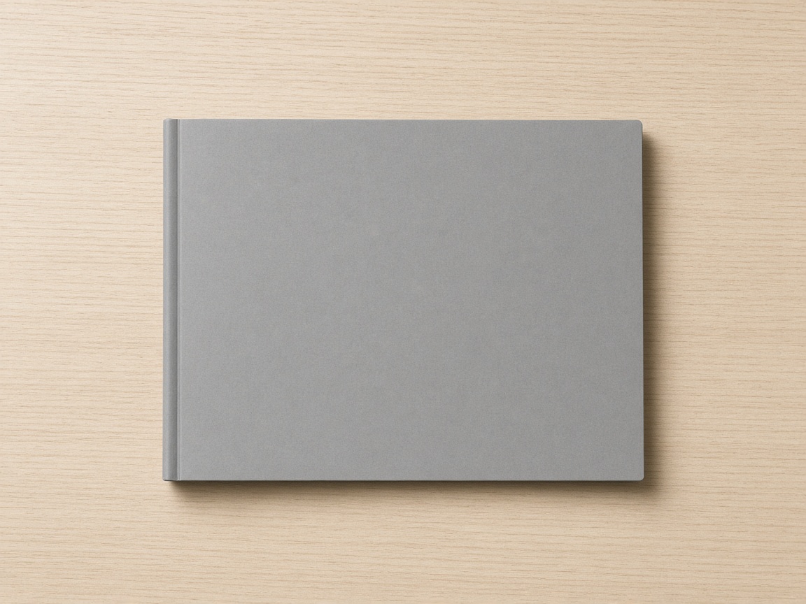 A closed unmarked gray folder centered on a pale wood desktop.